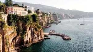 a large body of water with buildings on a cliff at Beatrice Room Bed&Breakfast in Sant'Agnello