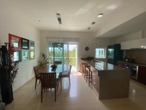 a kitchen with a table and chairs and a dining room at Prime 1 Bedroom Condo in Historic Downtown Playa del Carmen in Playa del Carmen