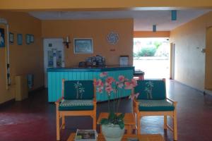 a room with two chairs and a table with flowers at Chrisanns Hidden Cove 2 bedroom in St Mary