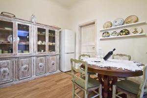 a dining room with a table and a refrigerator at San Marco Apartment in Florence