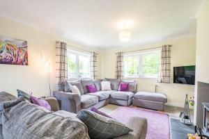 a living room with two couches and a tv at Falla Farmhouse in Jedburgh