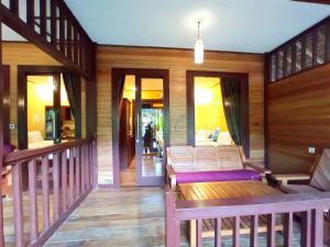 a living room with wooden walls and wooden floors at Giliranta in Gili Trawangan