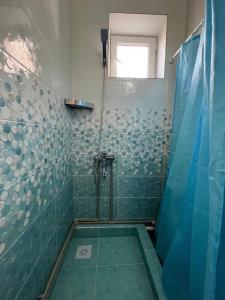 a bathroom with a shower with blue tiles at Tan Nuru Guest House Гостевой Дом Тан Нуру in Cholpon-Ata +161 photos