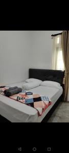 łóżko z kocem na górze w obiekcie ZG Home Solo w mieście Bonorejo