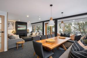 a dining room and living room with a table and chairs at Golden Eagle 2 in Thredbo