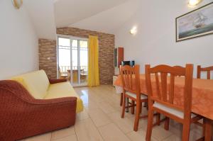 a living room with a couch and a dining room table at Vila Ana Mirela in Slatine