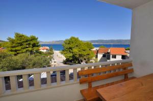 a balcony with a bench and a view of the water at Vila Ana Mirela in Slatine
