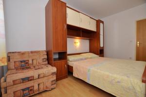 a bedroom with two beds and a large cabinet at Vila Ana Mirela in Slatine