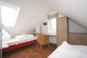 En eller flere senge i et værelse på Feriendorf Robbenplatte Burhave 4