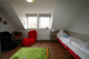 En eller flere senge i et værelse på Feriendorf Robbenplatte Burhave 4 + 13 billeder