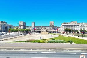 a city with a monument in the middle of a street at The Four Seasons - Panoramic View - Niemeyer Volcano View in Le Havre