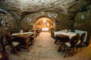 a dining room with tables and chairs in a stone building at HOTEL MARION in Dumbrăveni