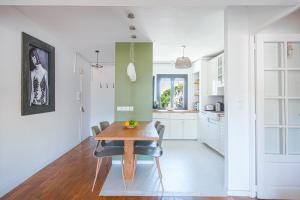 een keuken en eetkamer met een houten tafel en stoelen bij Un balcon sur Notre Dame in Marseille +7 foto's