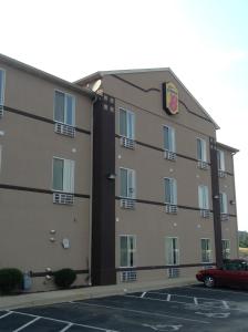 a building with a car parked in a parking lot at Super 8 by Wyndham Corydon in Corydon