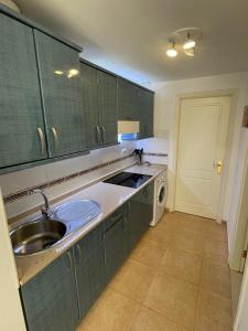 a kitchen with a sink and a dishwasher at Casa Julia - OASIS PAPAGAYO in Corralejo