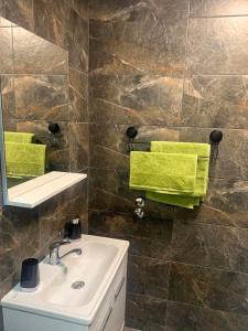 a bathroom with a sink and a mirror at Puro Urban in Ohrid +4 photos