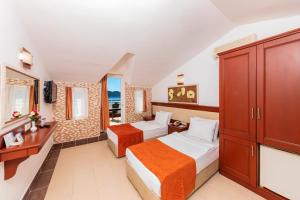Postel nebo postele na pokoji v ubytování Kayamaris Hotel