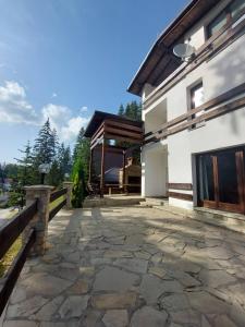 a stone patio in front of a building at Apartments Žera in Vlasic
