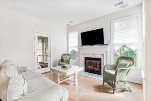a living room with a couch and a fireplace at Bayside Bethany Lakes --- Old Mill Way #6 in Ocean View