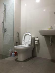 a bathroom with a toilet with the seat up and a sink at Lucky Continew Residence 1 Bedroom - TRX KL in Kuala Lumpur