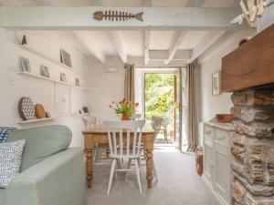 a living room with a table and a couch at Oyster Cottage in Salcombe