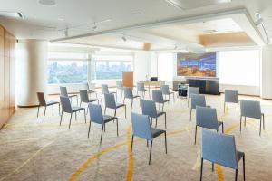 a room with chairs and tables and a large window at Odakyu Hotel Century Southern Tower in Tokyo