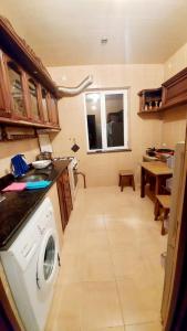 a kitchen with a washing machine in a room at NOD VILA in Chakvi