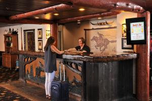 two women standing at a bar in a lodge at Stoney Creek Hotel St. Joseph in Saint Joseph