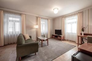 a living room with a couch and a tv at Pension Křivá in Olomouc