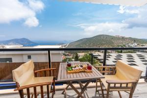 a table and chairs on a balcony with a view at Villa Parle in Kalkan
