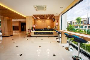 a lobby with a bar and chairs in a building at Siri Hotel Lumphun in Ban Pa Daet