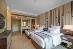 Postel nebo postele na pokoji v ubytování Grand Pacific Hotel Ningbo