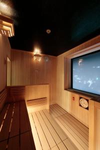 a sauna with a large flat screen tv at Candeo Hotels Nagasaki Shinchi Chinatown in Nagasaki