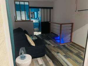 - un salon avec un canapé noir et une table dans l'établissement L’enraguer, à Marseille