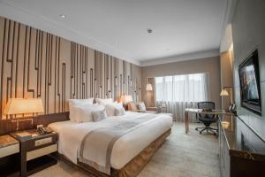 Postel nebo postele na pokoji v ubytování Grand Pacific Hotel Ningbo