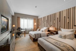 Postel nebo postele na pokoji v ubytování Grand Pacific Hotel Ningbo