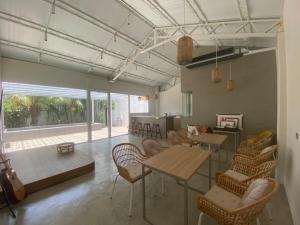 a room with tables and chairs and a guitar at Sailing Inn in Donggang