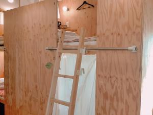 una puerta de madera con una escalera en una habitación en Saga International Guesthouse Hagakure, en Saga