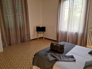 a hotel room with a bed and a television at FRANGI HOUSE in Pescara