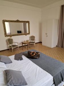 a bedroom with a large bed and a mirror at FRANGI HOUSE in Pescara