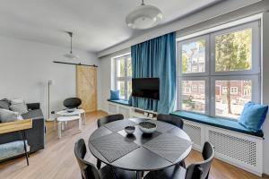een woonkamer met een tafel en een bank bij 4 Lions Grobla in Gdańsk