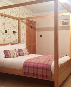 a bedroom with a bed with a wooden frame at Island View House in Ullapool