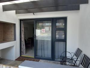 an entrance to a building with a glass door at High Level Self Catering in Agulhas