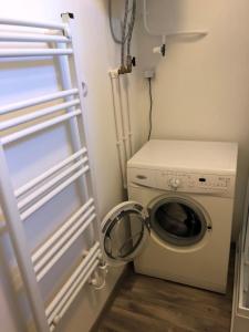 a laundry room with a washing machine and a washer at Karman Apartman - 2 bedroom entire flat in the center in Jászberény