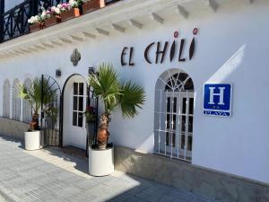 a white building with a sign on the side of it at El Chili Boutique Hotel in Barbate