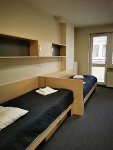 Postel nebo postele na pokoji v ubytování Dom Studencki Zaułek