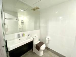 a white bathroom with a toilet and a sink at STUDIO DESIGN 5 ETOILES Resort in Bang Rak Beach