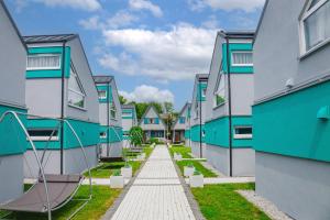 a row of houses with a pathway between them at Ośrodek Sea Star Premium in Sarbinowo