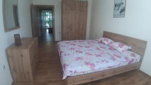 a bedroom with a bed and a wooden dresser at Apartment V in Ohrid
