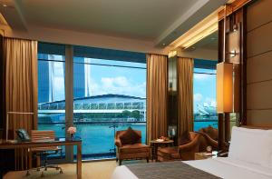 a hotel room with a view of a stadium at The Fullerton Bay Hotel Singapore in Singapore